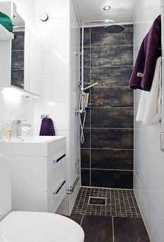 a bathroom with a toilet, sink and shower