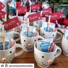 coffee cups with candy canes and marshmallows in them for sale at a christmas market