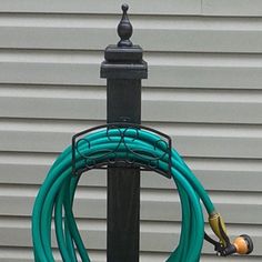 there is a hose attached to a pole