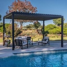 an outdoor patio with chairs and tables next to a swimming pool