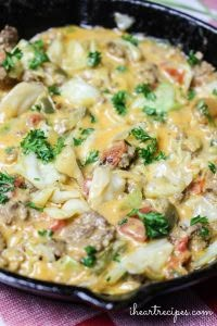 a skillet filled with pasta and meat covered in cheese