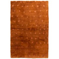 an orange area rug with small dots on the top and bottom, in different colors