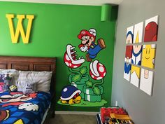 a child's bedroom decorated in green and blue with an image of mario on the wall