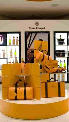 a display in a store filled with lots of yellow bags and suitcases stacked on top of each other