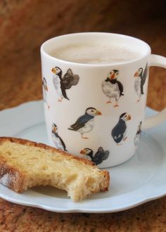 a cup of coffee and some bread on a plate