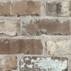 an old brick wall with peeling paint and chippings on the bricks, as well as rust