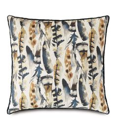 a white and blue pillow with feathers printed on it's side, in front of a white background