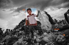 a young boy standing on top of a pile of rubble next to a plastic bag