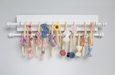 a wall mounted rack with many different types of hair clips