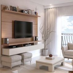 a living room with white furniture and a flat screen tv mounted to the side of a wall