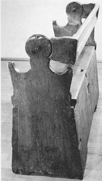 an old wooden chair sitting on top of a hard wood floor next to a wall