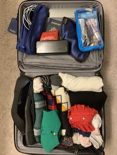 an open suitcase filled with clothing and other items