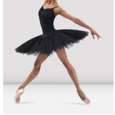 a young ballerina in a black leotard and tutu