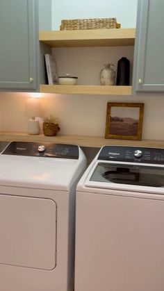 a washer and dryer are sitting next to each other in the laundry room