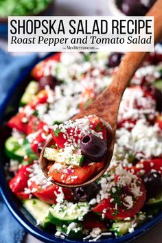 a spoon full of greek salad with tomatoes, cucumbers and feta cheese