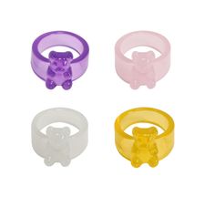 three rings with teddy bears on them are shown in four different colors and sizes, one is yellow, the other is purple