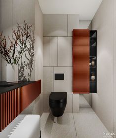 a bathroom with a black toilet sitting next to a wooden cabinet and shelf on the wall