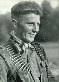 an old black and white photo of a man in uniform