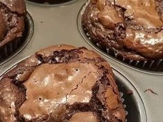 several chocolate muffins sitting in a cupcake tin on top of a counter