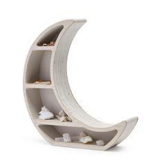 a white shelf that has some rocks in it and is shaped like a half moon