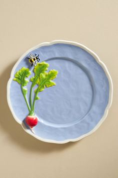 a plate with a beet and radishes painted on the side, sitting on a table