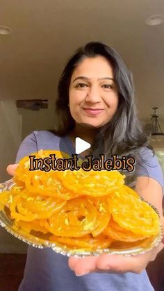 a woman holding a plate full of sliced oranges with the words instant jellies on it