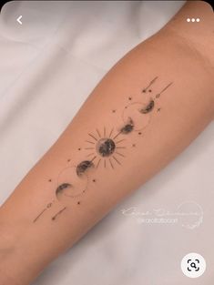 a woman's arm with the sun and moon tattoos on it