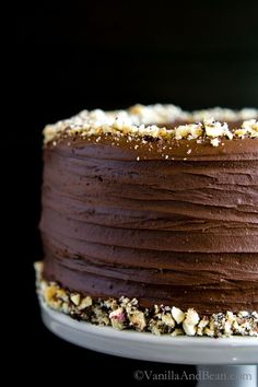 a close up of a cake on a plate with chocolate frosting and sprinkles