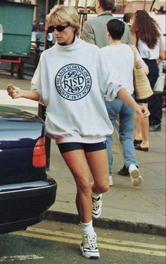 a woman walking down the street in shorts