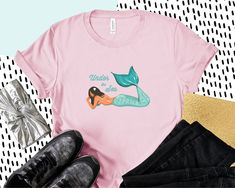 Lovely Mermaid Under the Sea logo on a Unisex t-Shirt. This updated unisex essential fits like a well-loved favorite. Super soft cotton and excellent quality print makes one to fall in love with it over and over again. .: Retail fit .: 100% Soft cotton (fibre content may vary for different colors) .: Light fabric (4.2 oz/yd² (142 g/m .: Tear away label .: Runs true to size Little Mermaid Shirt, Sea Logo, Disney Bachelorette, Disney Princess Shirts, Slayer Shirt, Sea Mermaid, Hawaii Aloha, Mermaid Under The Sea, Mermaid Shirt