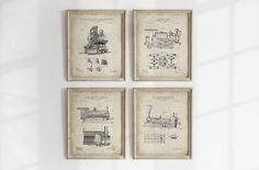 four framed drawings of trains on a wall