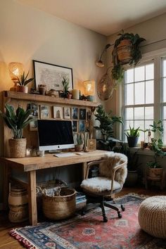 a desk with a computer on top of it next to a chair and potted plants