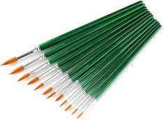 the green and orange paint brushes are lined up in a row on top of each other