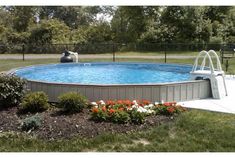 an above ground swimming pool surrounded by flowers