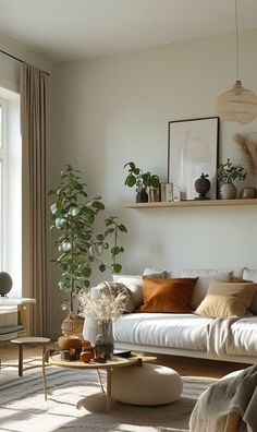 a living room filled with lots of furniture and plants on top of the windowsill