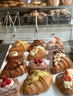 there are many croissants and pastries on the counter