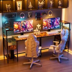 two white chairs sitting in front of a desk with computer monitors on top of it