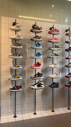 there are many pairs of shoes hanging on the wall