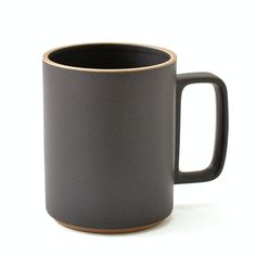 a black and brown coffee mug on a white background