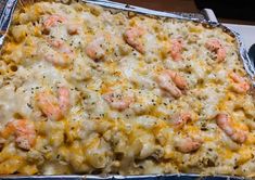 a casserole dish with shrimp and cheese in it