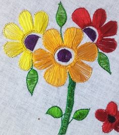 a close up of a flower on a piece of cloth