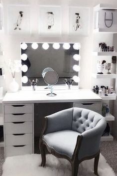 a chair sitting in front of a vanity with lights on it