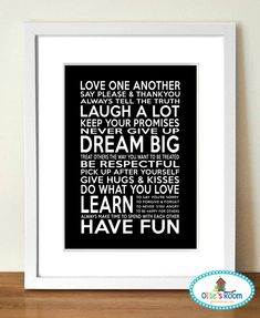 a framed black and white poster with the words love one another