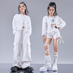 two models in white outfits standing next to each other with their hands on their hips