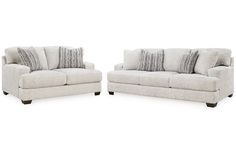 two white couches sitting next to each other