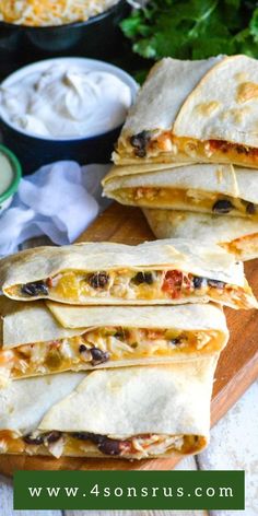 four quesadillas on a cutting board with dip