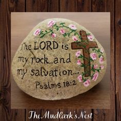 a rock with a cross painted on it that says the lord is my rock and my salvation