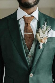 a man in a suit and tie with a boutonniere on his lapel