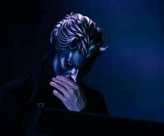 a man with his face covered in blue light