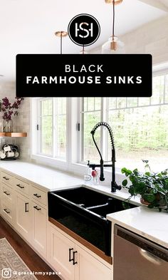 black farmhouse sink in the middle of a kitchen with white cabinets and counter tops, surrounded by greenery